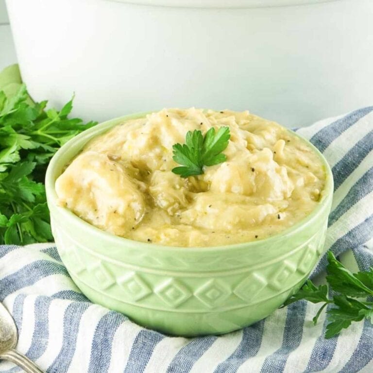 a soup bowl filled with slow cooker chicken and dumplings made from biscuits