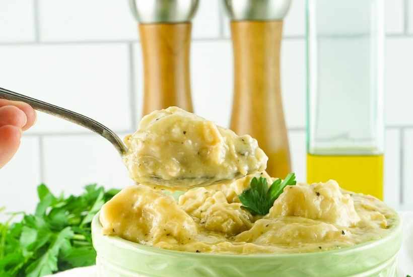 a scoop of slow cooker chicken and dumplings on a spoon