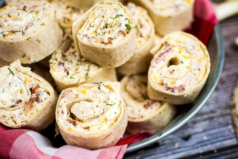 closeup view of crack chicken pinwheels on a serving platter.