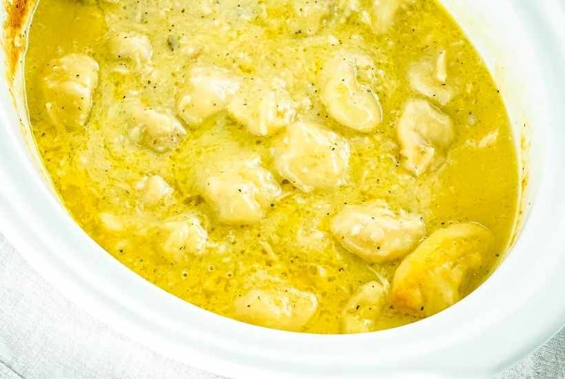 top view of chicken and biscuit dumplings in the crockpot