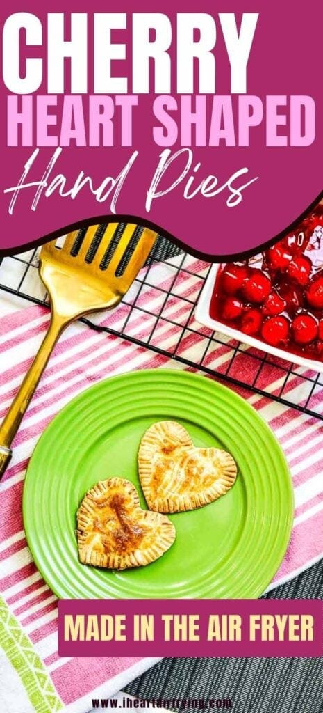 close up of two heart shaped air fryer hand pies on a green plate with text overlay