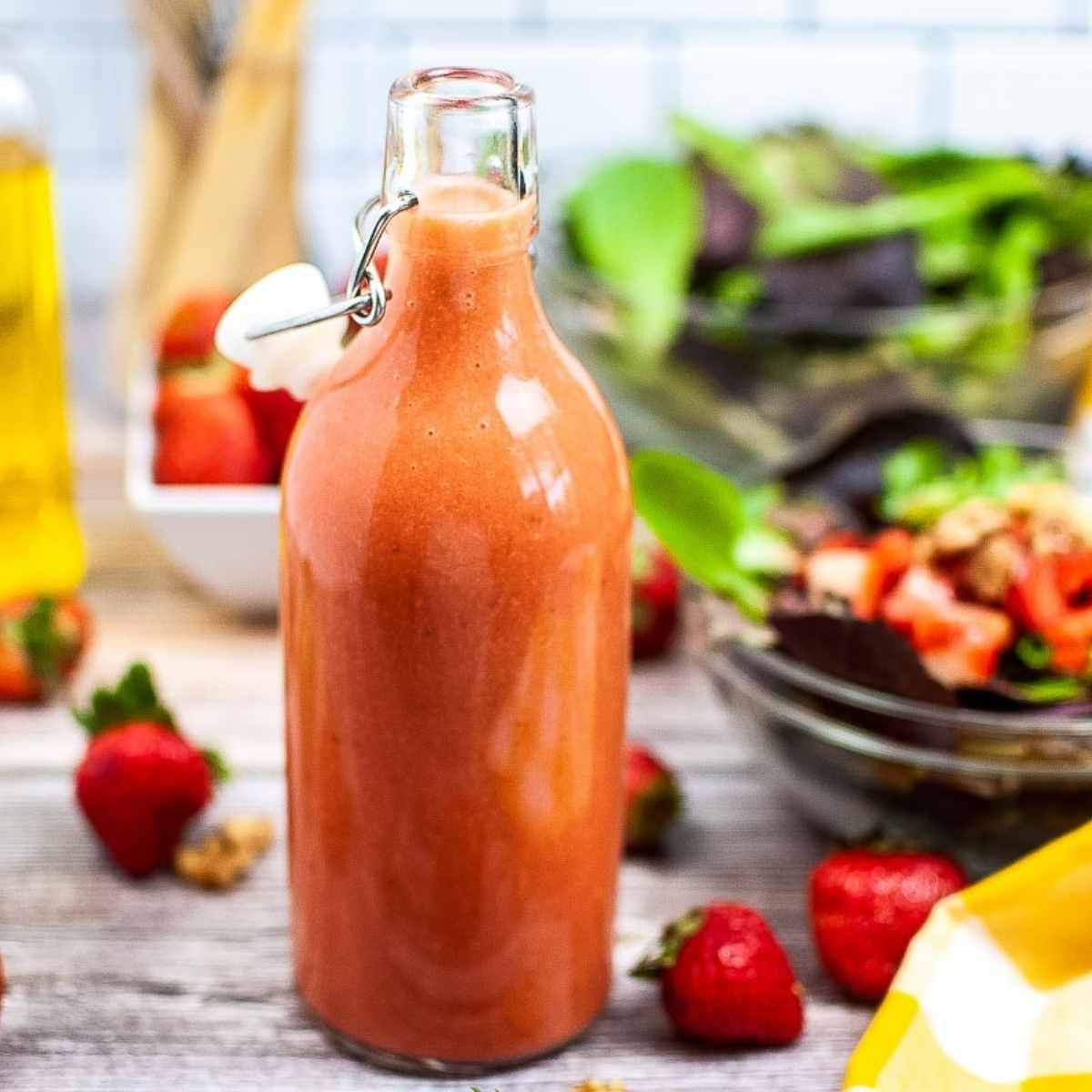 Strawberry lime Vinaigrette in a tall glass bottle.