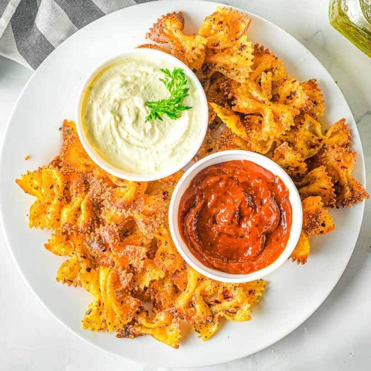 air fryer pasta chips on a plate with marinara and feta dip