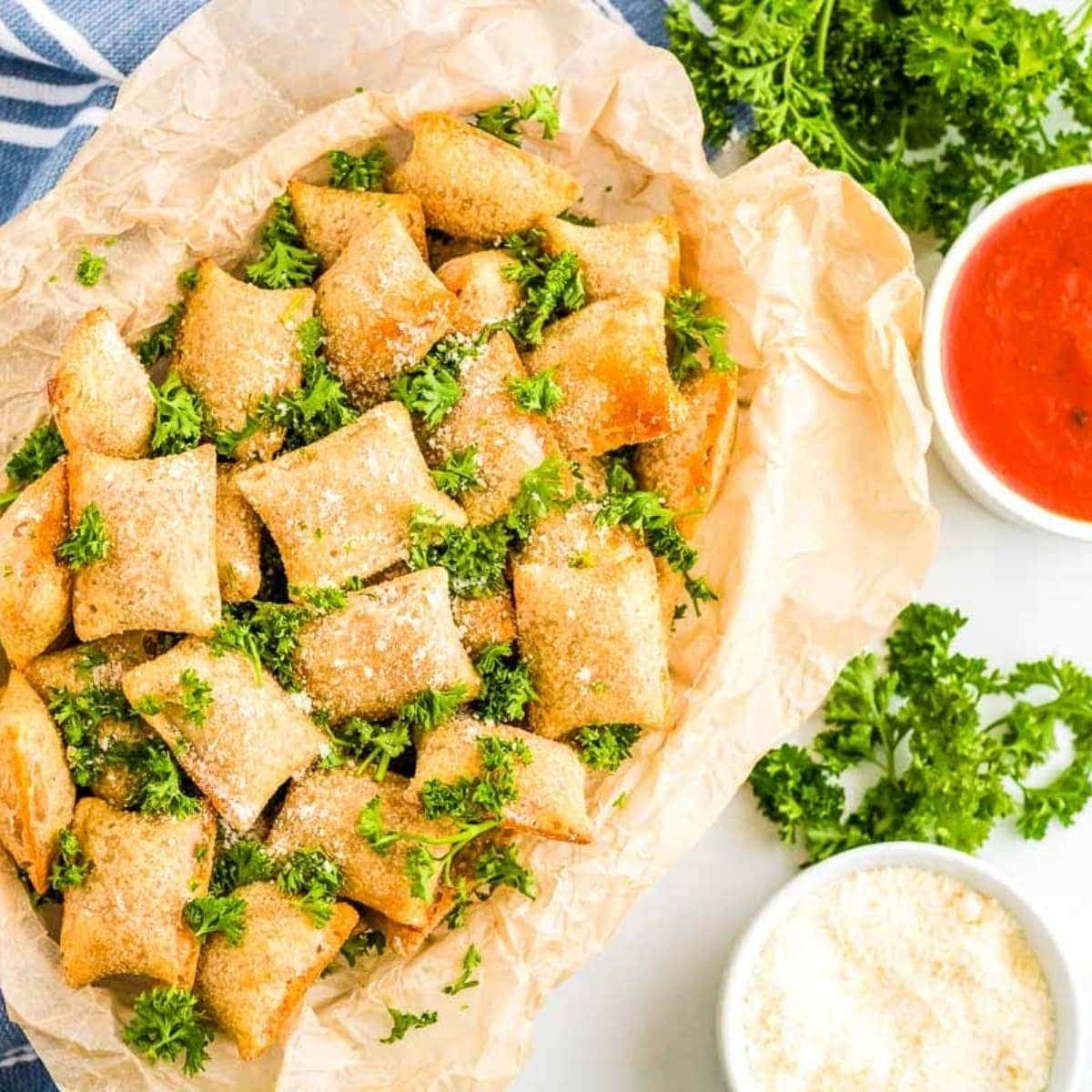 air fryer pizza rolls on a serving dish next to dipping sauces