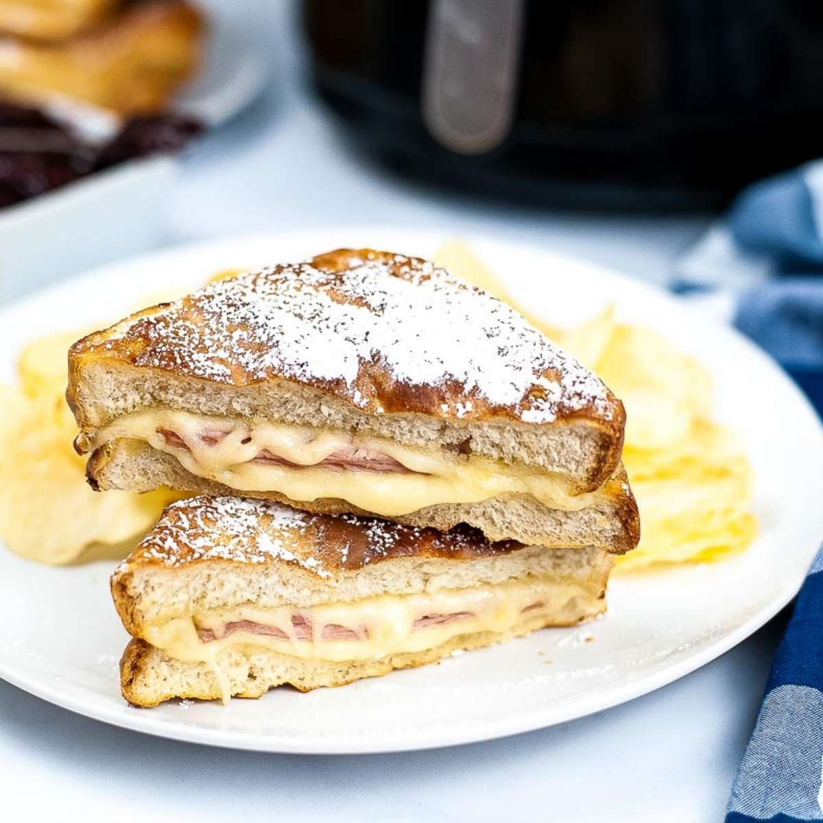 close up of air fryer monte cristo sandwich cut in half stacked on top of each other