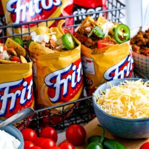 walking tacos in Fritos bags with a bowl of shredded cheese and toppings