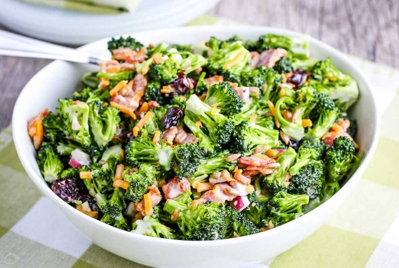 White bowl filled with broccoli bacon cranberry salad.