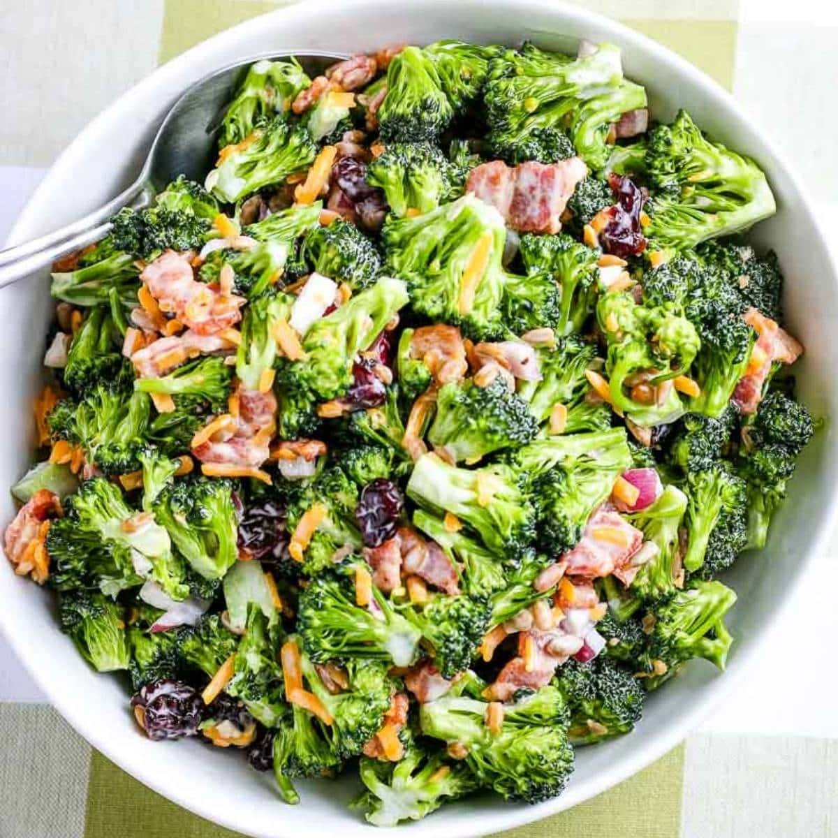 closeup of bowl of broccoli salad with bacon and cranberries