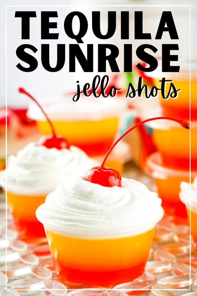 two tequila sunrise jello shots with whipped cream and cherries with text overlay