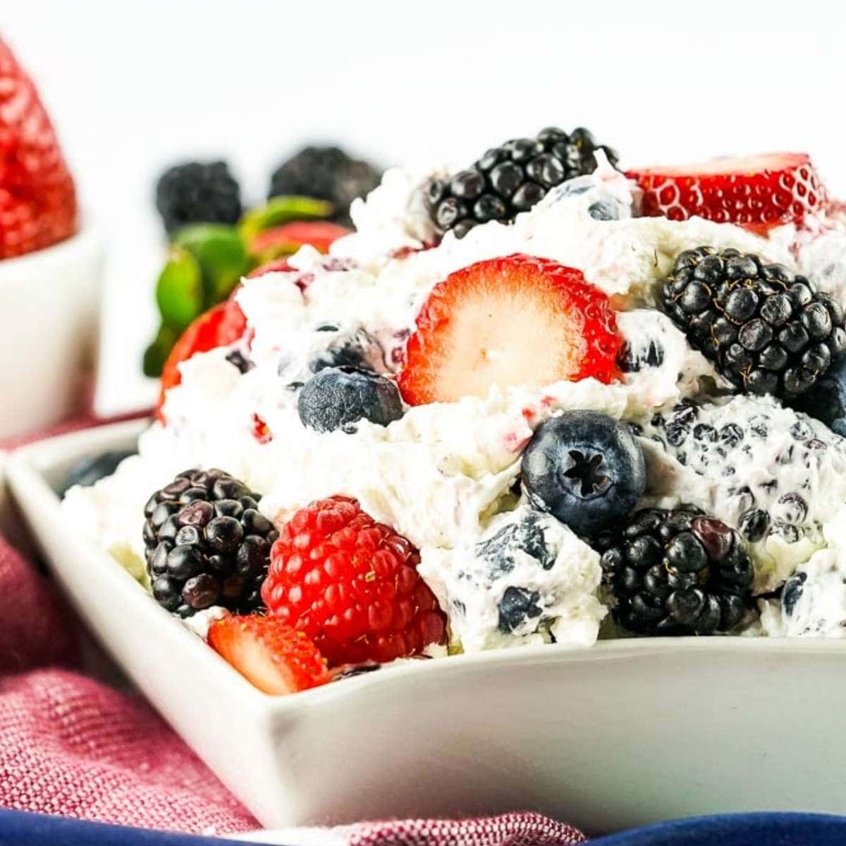 berry cheesecake salad in a small white square bowl