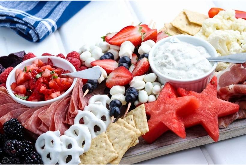 4th of july charcuterie board with fruit, meat, and cheeses