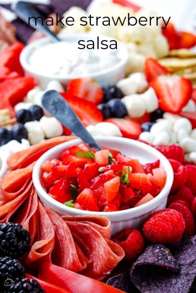 strawberry salsa surrounded by fruit on a charcuterie board