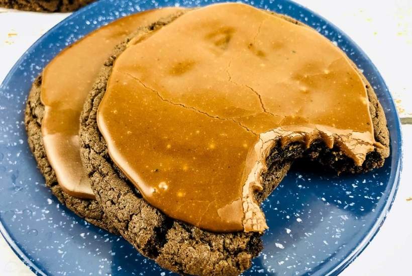 two sheetcake cookies on a blue plate one with a bite taken out.