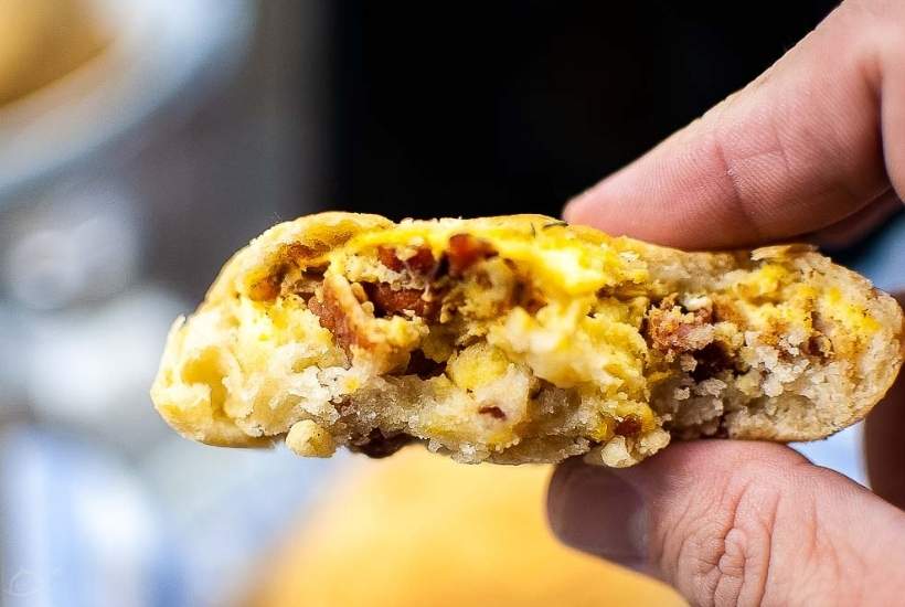 holding an air fried breakfast bomb that has been bitten in half