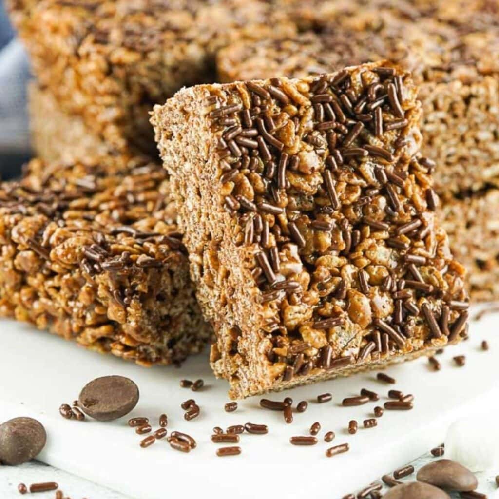 squares of chocolate rice krispie treats with brown sprinkles on top