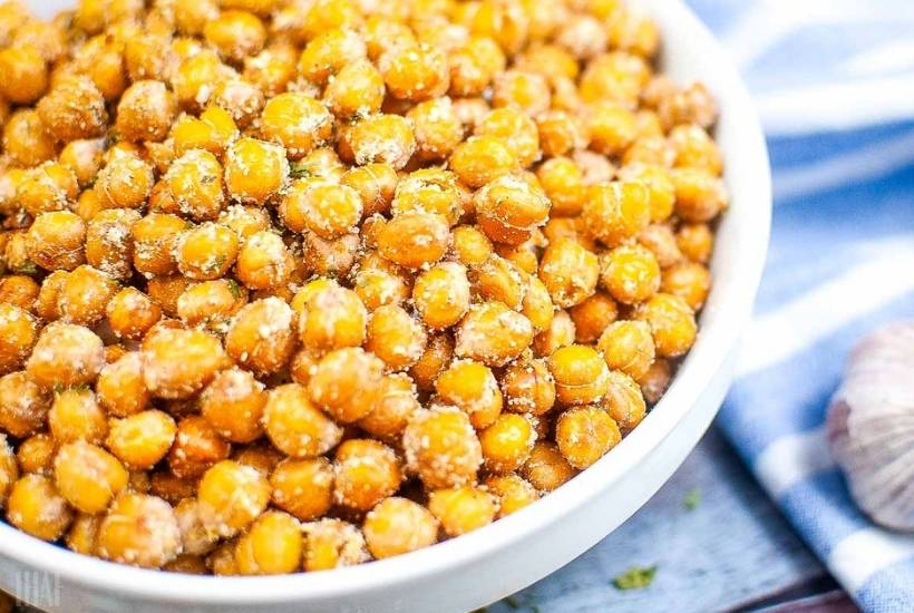 air fried ranch chickpeas in a white bowl next to a blue and white towel