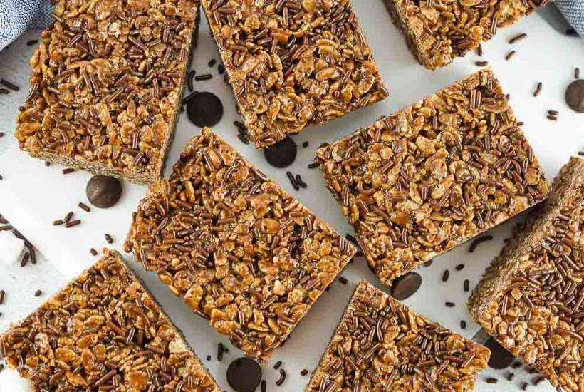 top view of chocolate rice krispie treats cut into squares with chocolate sprinkles on top.