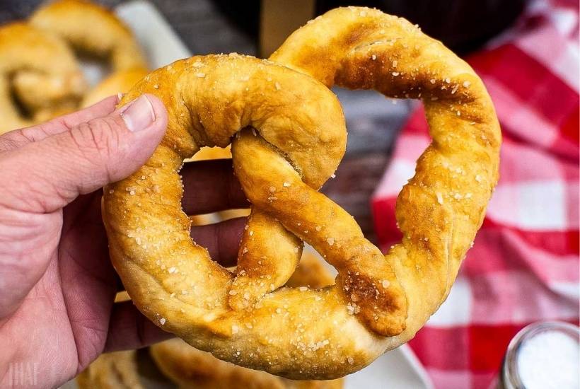 closeup up holding an air fried soft pretzel