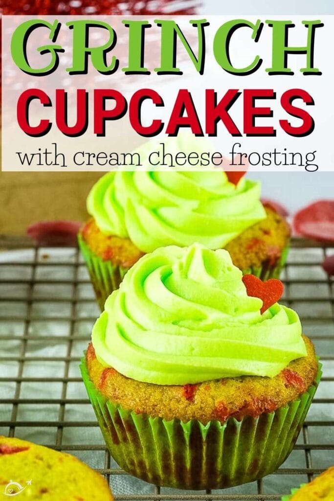 close up of two Grinch cupcakes on a cooling rack with text overlay.