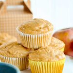 Close up view of a stack of apple muffins with oats.