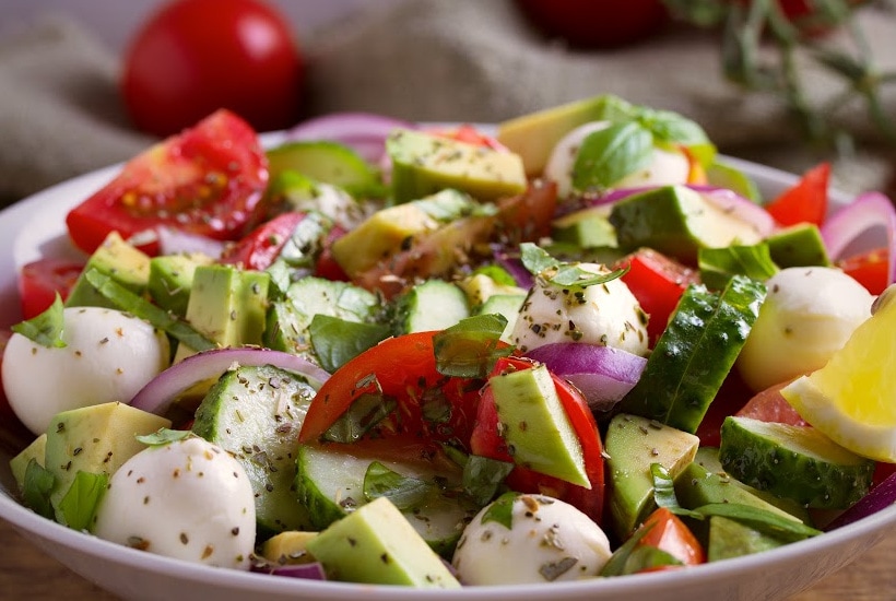 a main course salad in a large white bowl.