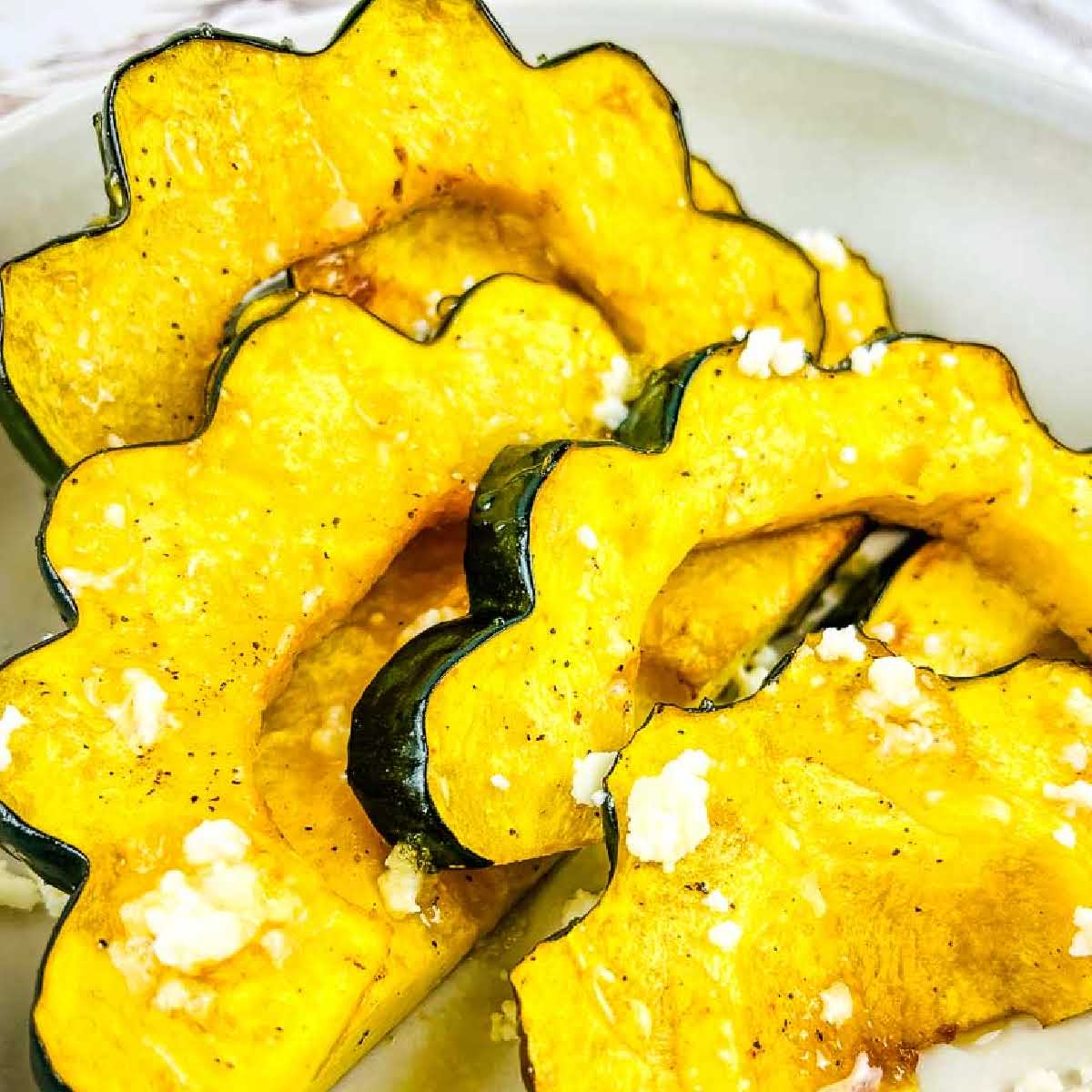 closeup view of sliced air fried acorn squash in a bowl.