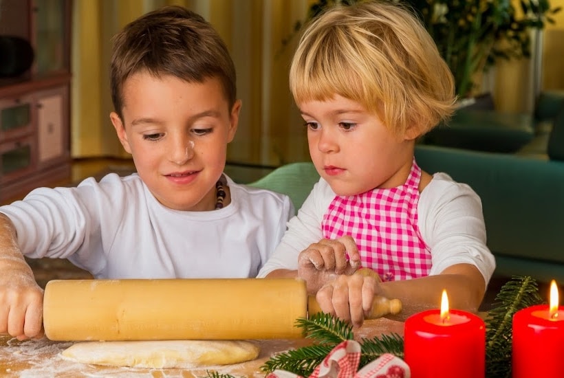 young boy and girl rolling out dough.