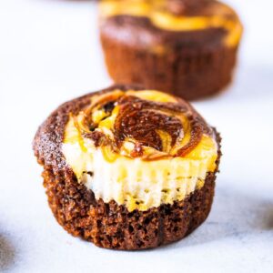 close up of two chocolate cheesecake muffins