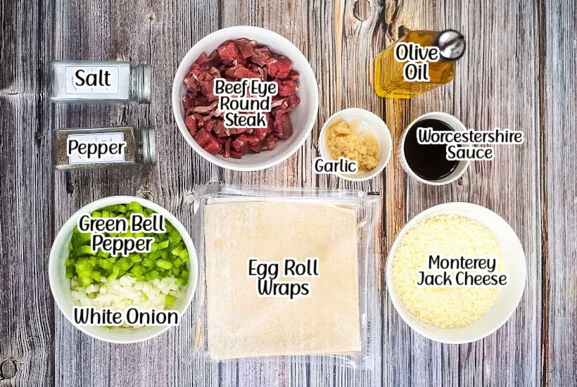 labeled ingredients to make air fryer cheesesteak egg rolls with text overlay.