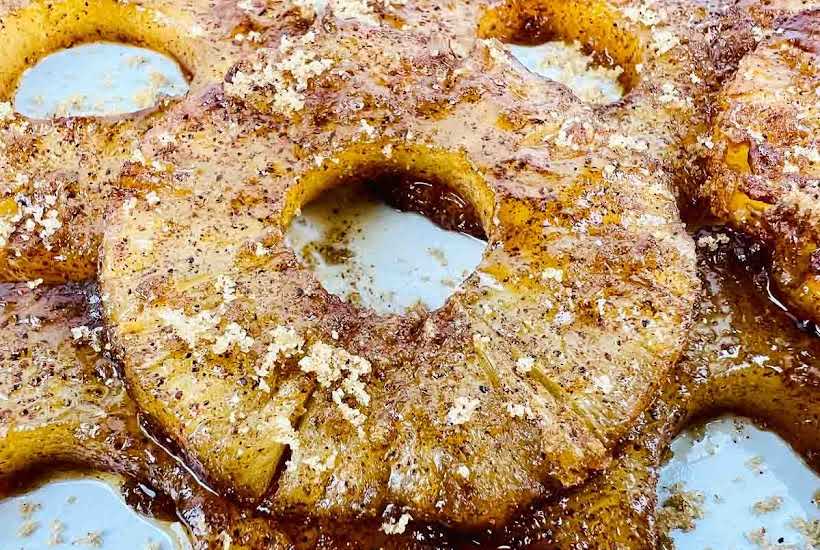 close up of air fried pineapple slices with cinnamon and sugar.