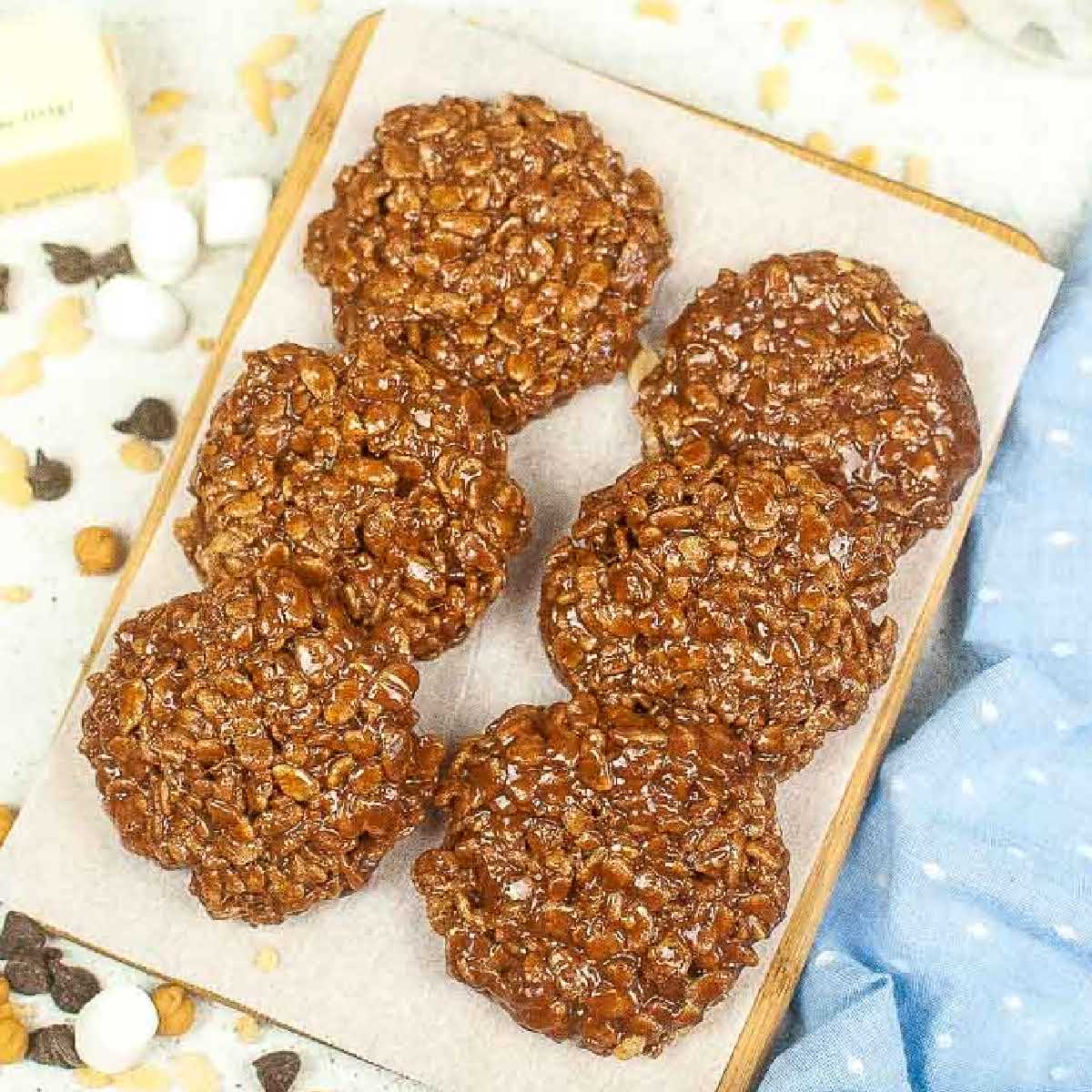 top view of 6 homemade star crunch cookies on parchment paper on a cutting board.