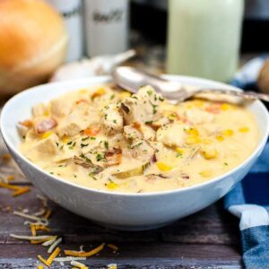 Front view of a bowl of Instant Pot Chicken Corn Chowder with a spoon on the side.