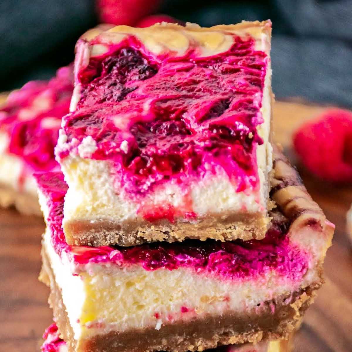 Two Raspberry Cheesecake Bars stacked on each other.