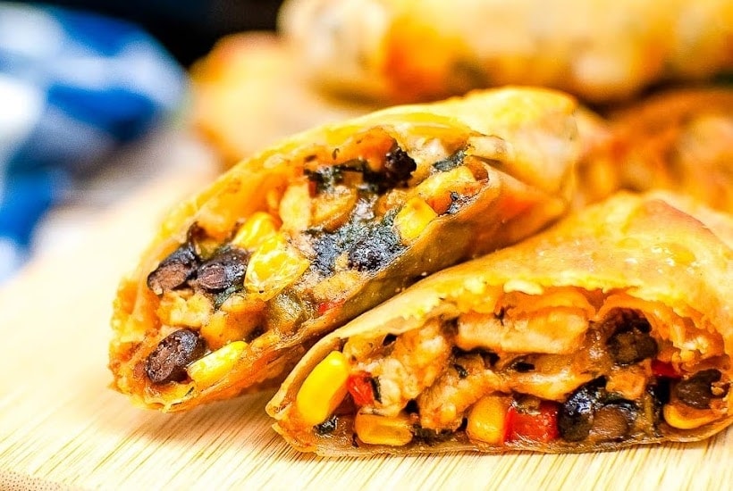 front close up of an air fried southwestern eggroll cut in half.