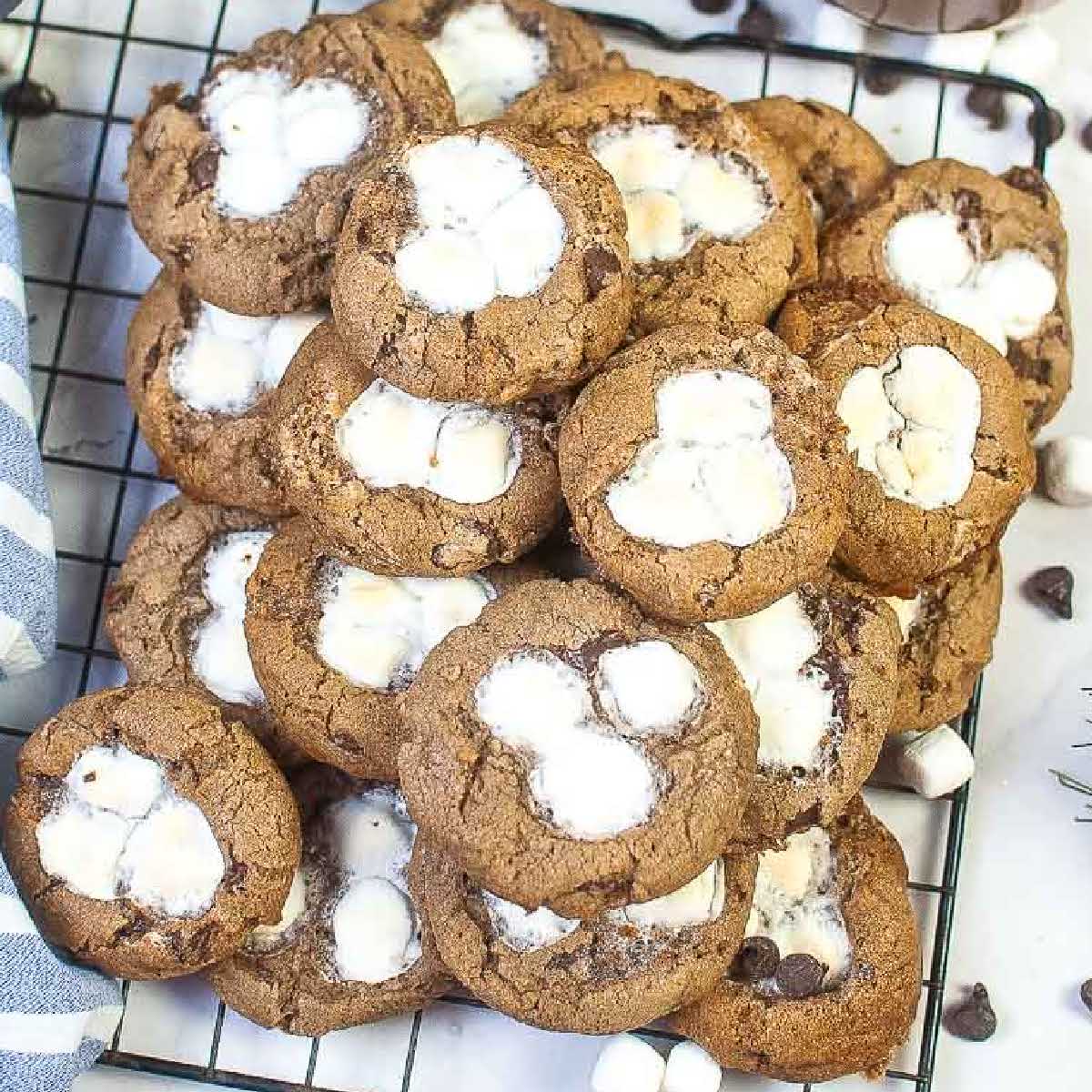 Overhead view of air fryer hot chocolate cookies with mini marshmallows on a cooling rack.