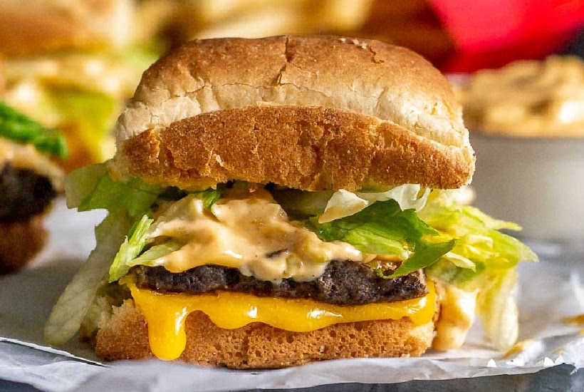 Front close up of homemade Big Mac slider on parchment paper.