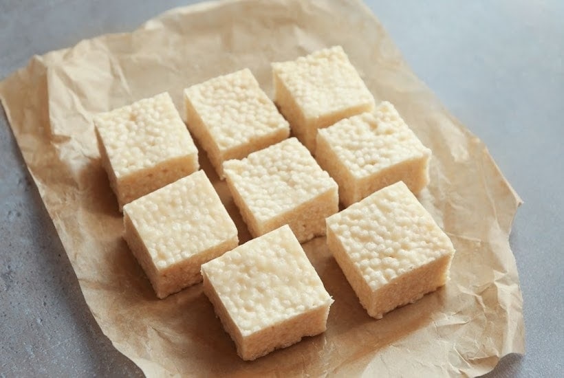 squares of food on a piece of parchment paper.