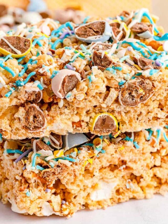 closeup view of two mini egg Rice Krispie treats stacked on a white plate.