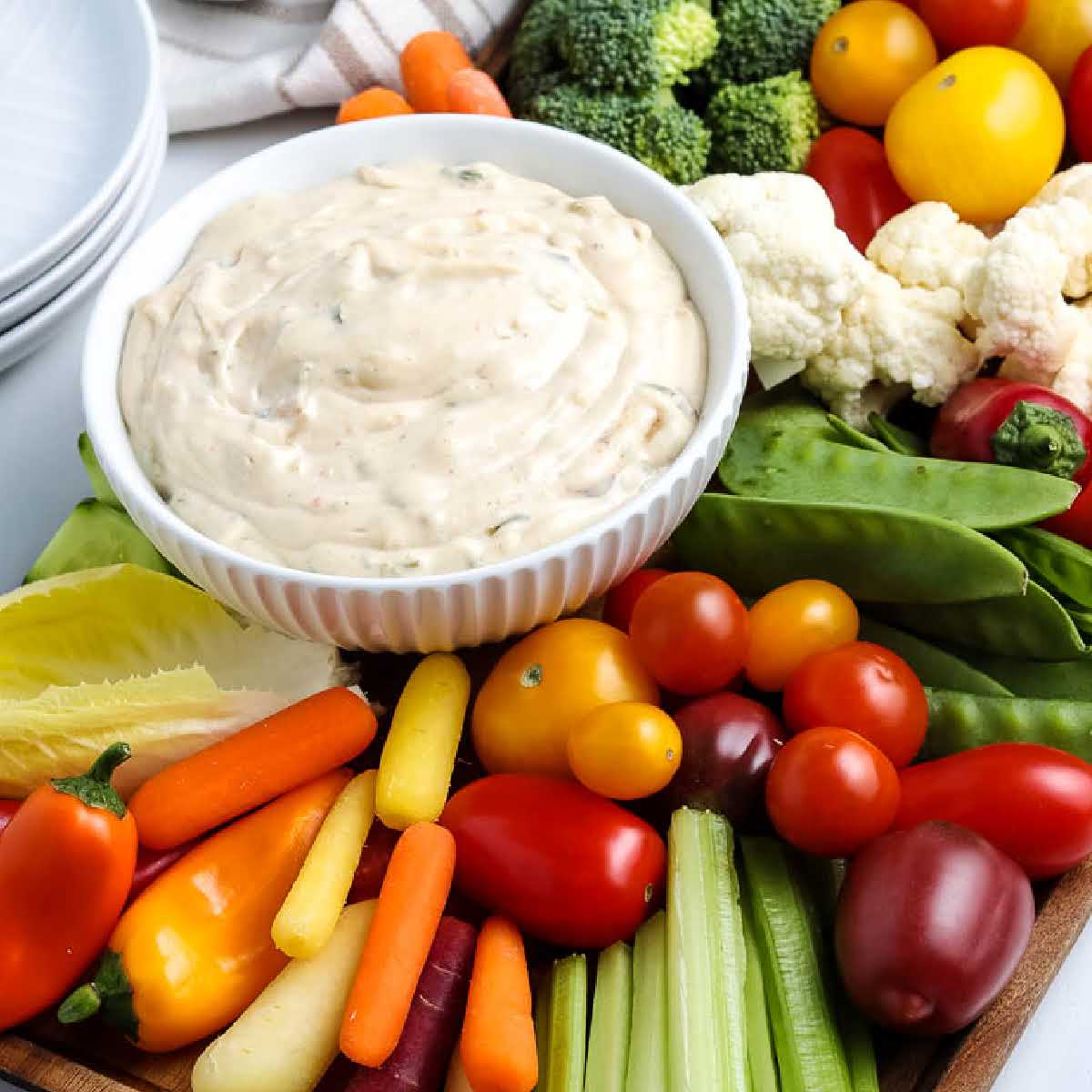 closeup view of crudite board with a bowl of creamy dip.