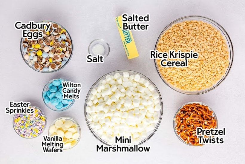 Labelled ingredients to make mini egg Rice Krispies treats on a white background.