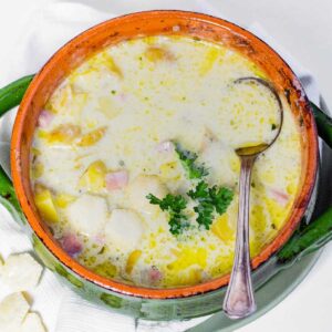 Top view of Slow Cooker Ham and Potato Soup in a soup bowl with a spoon.