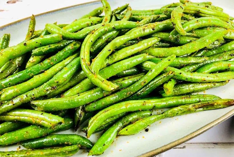 Roasted green beans on a serving platter.