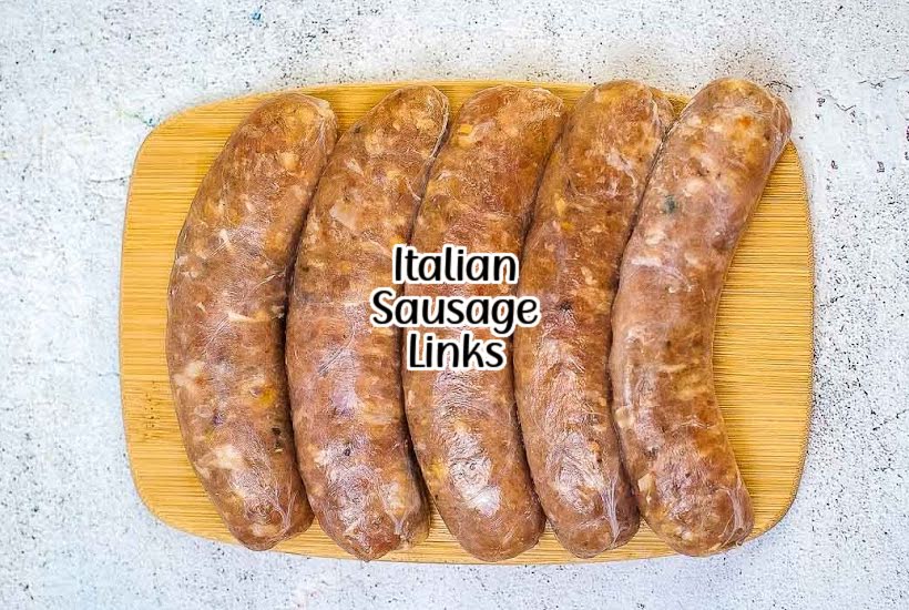 Overhead view of raw Italian sausage links on a cutting board.