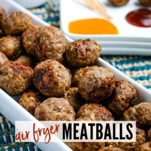 Closeup view of air fryer meatballs in a white bowl with dipping sauces in the background and with text overlay.