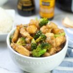 Bowl filled with air fried chicken and broccoli.