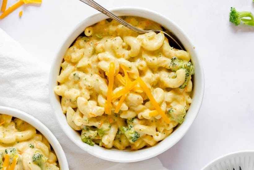 Overhead view of Panera Broccoli Cheddar Mac and Cheese in a small white bowl with a spoon.