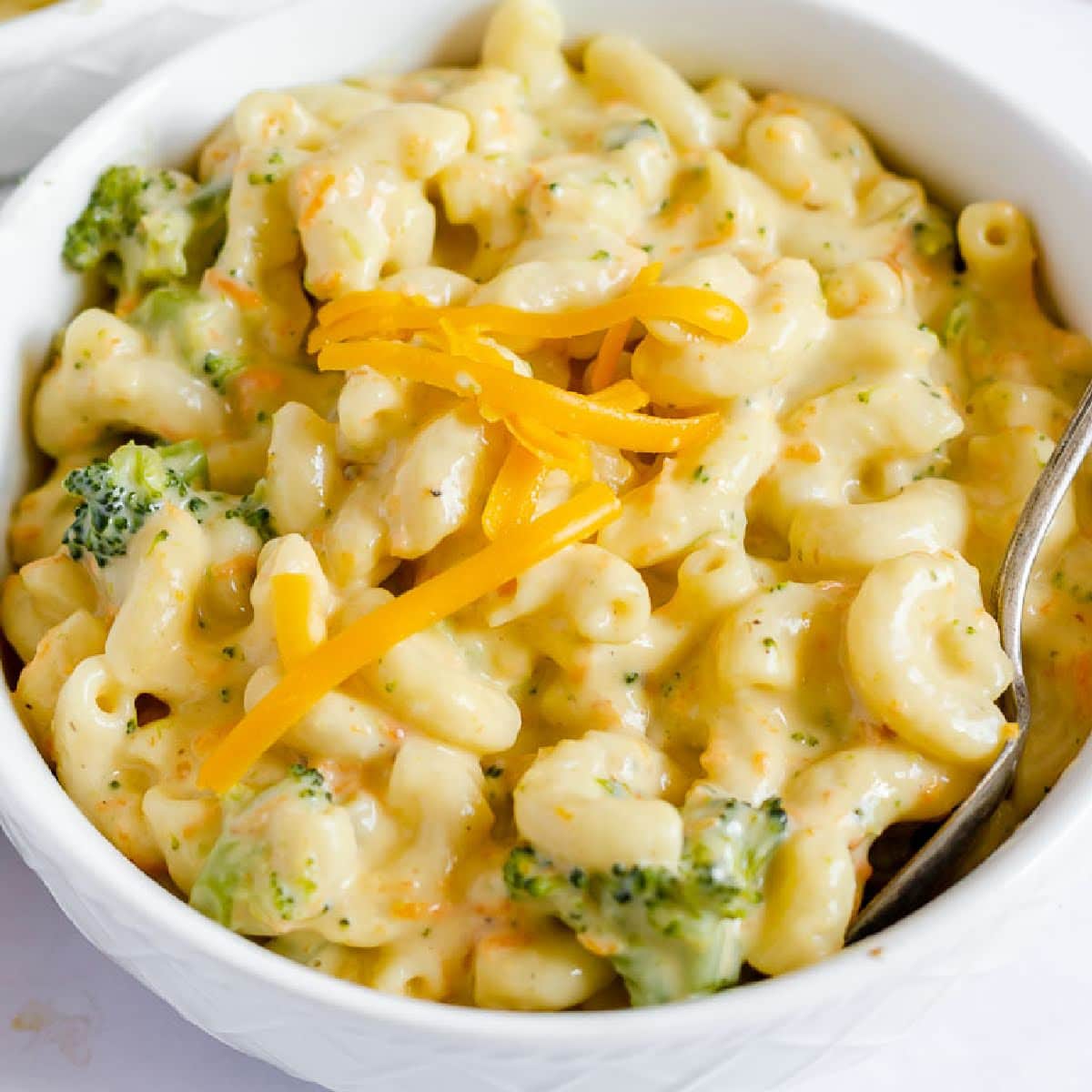 Overhead close up view of Panera Broccoli Cheddar Mac and Cheese in a white bowl.