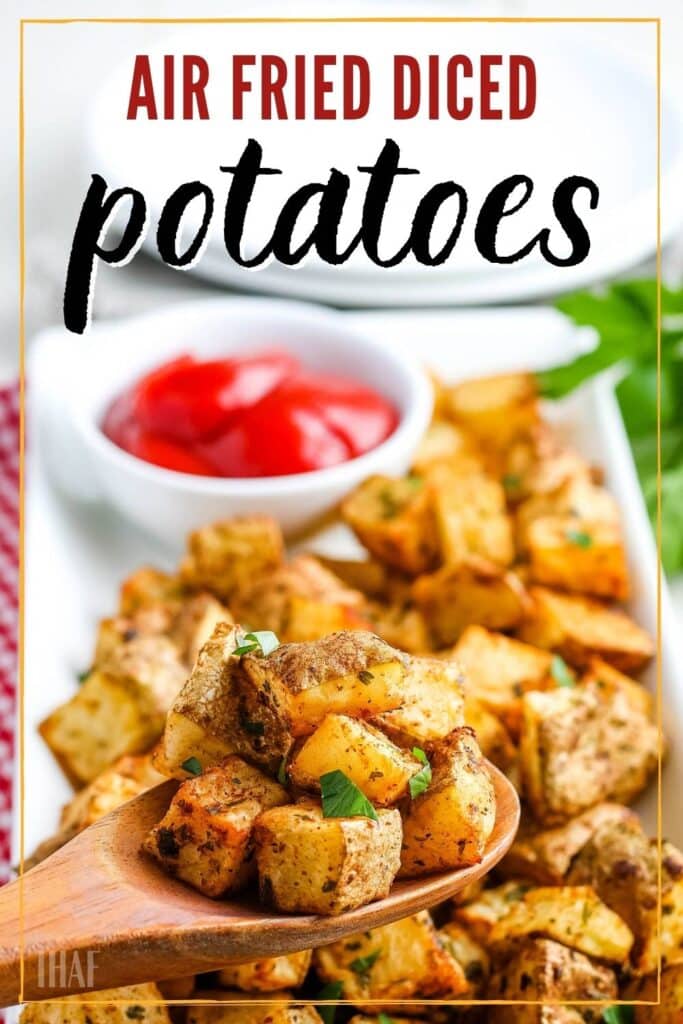 Air fried diced potatoes on a wooden spoon with platter in the background with text overlay.