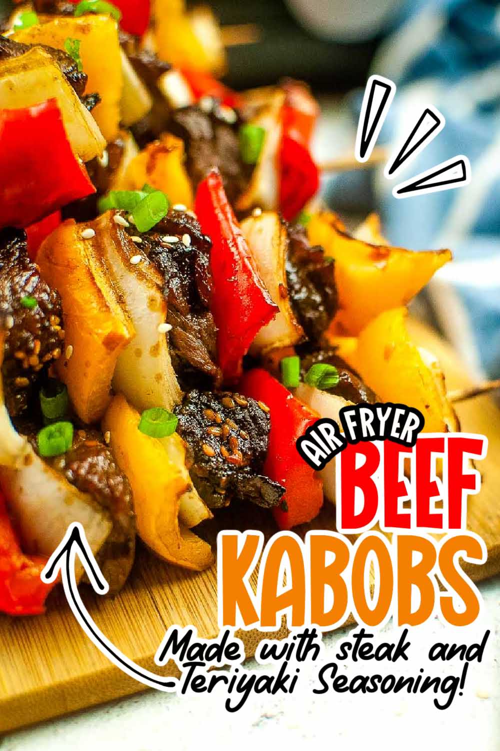 Air fried beef kabobs with peppers and onions on a wooden cutting board with text overlay.