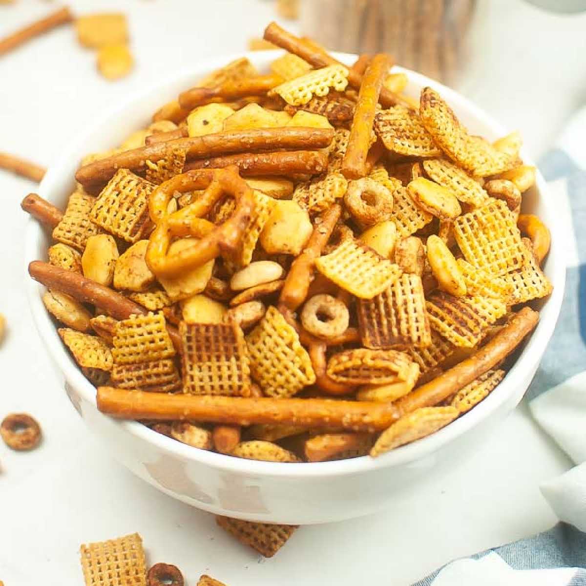 A white bowl filled with Air Fryer Chex Mix.